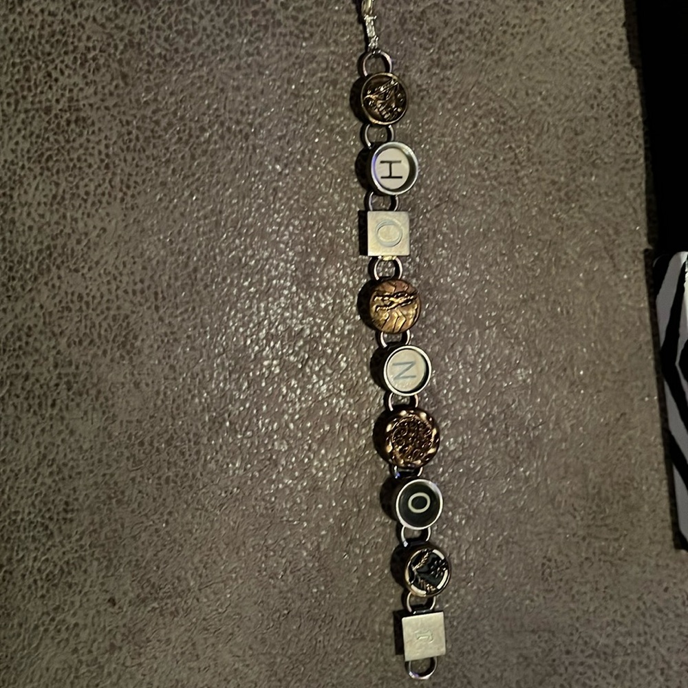 Recycled bracelet made from typewriter keys says honor